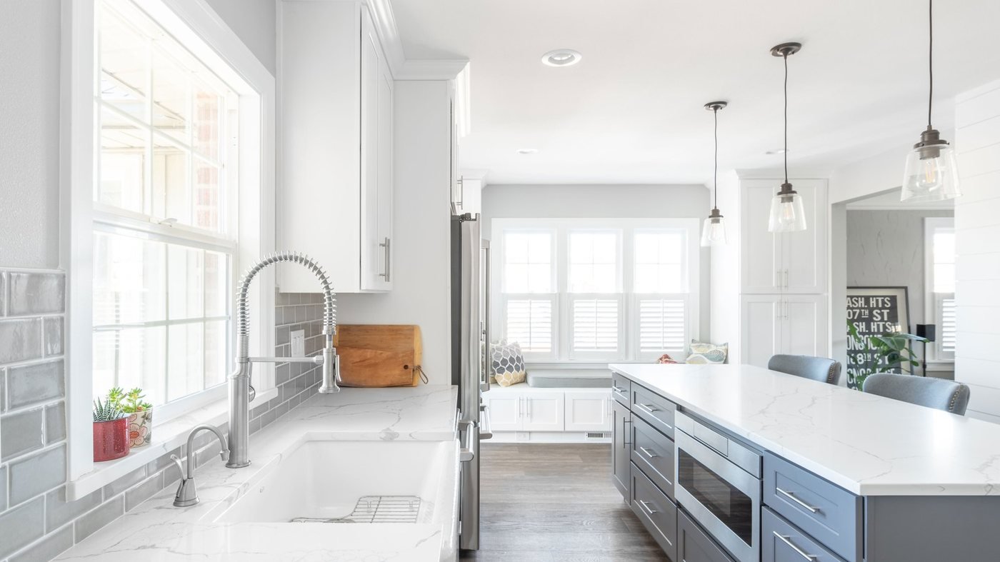 Bright remodeled kitchen with a large island and pendant lights