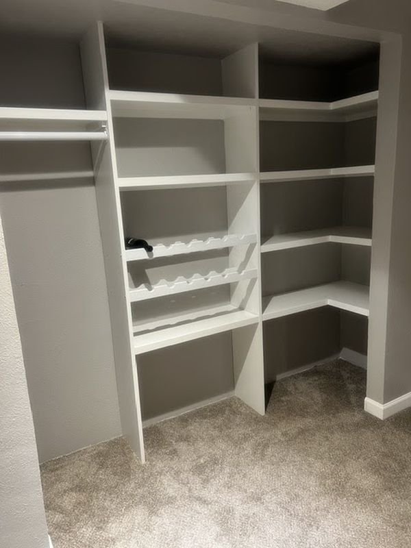 The same closet after: built-in shelving, hanging space and a corner shelf tower