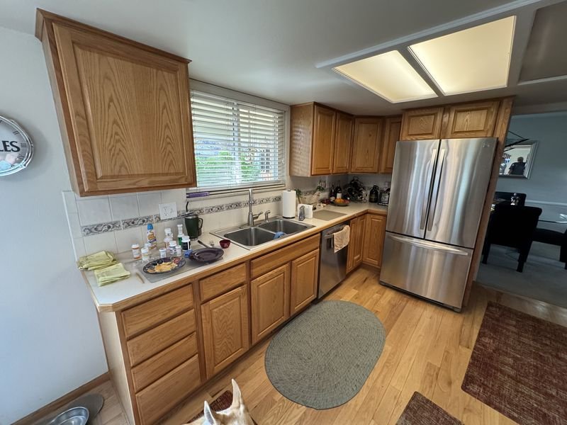 Kitchen before: oak cabinets, laminate counters and a recessed fluorescent ceiling light box