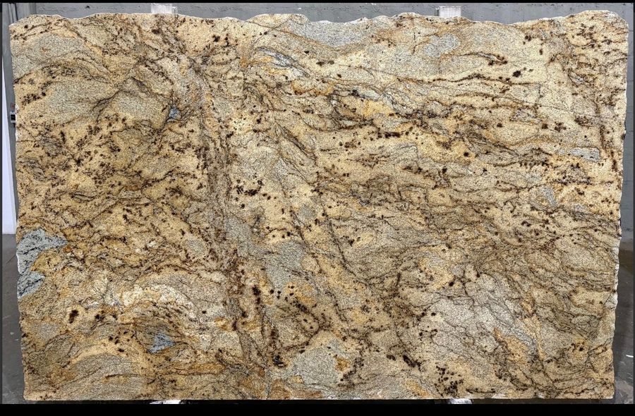 Golden Crystal granite slab, warm gold and brown with dark speckling