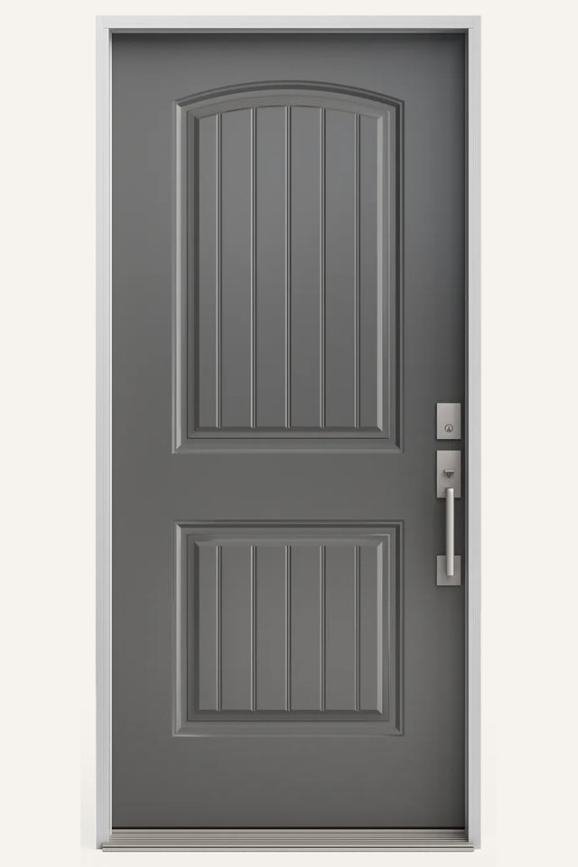 Front view of a closed grey fiberglass exterior door, opaque two panels with planks, top panel curved, and a door handle
