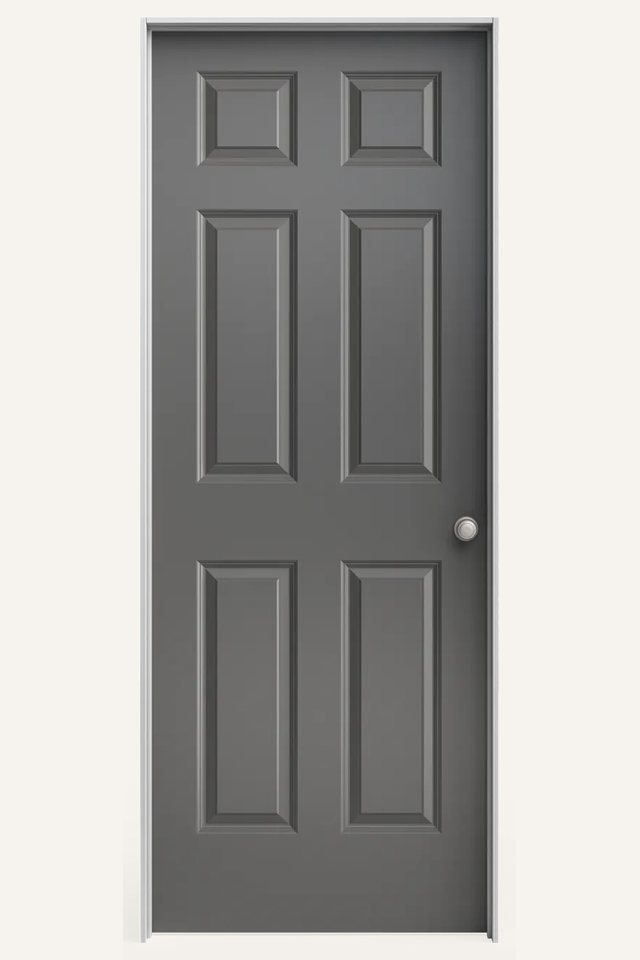 Frontal view of a closed interior 6 traditional gray panel door, with a silver round handle on the right side.