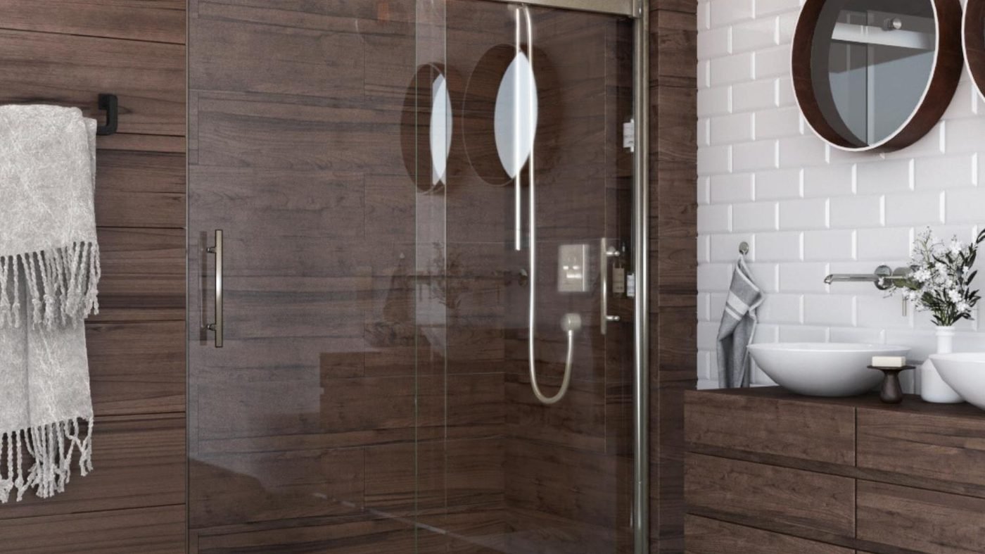 A walk in shower lined in weathered wood-look plank tile, behind a black barn-style sliding glass door, over a woven basketweave tile floor